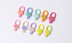 Detail of colorful flower-shaped lobster clasps and alloy spring rings for DIY crafts