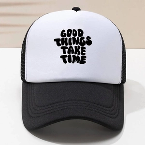 Close-up of GOOD THINGS TAKE TIME print on black and white mesh trucker hat