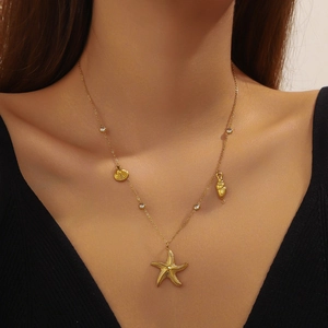 Gold plated stainless steel necklace featuring starfish, shell and conch pendants