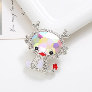Detail of a sparkling silver cartoon deer brooch with rainbow crystals on white background