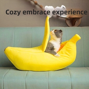 Detailed view of banana-shaped plush pet bed with a cat resting inside on a sofa