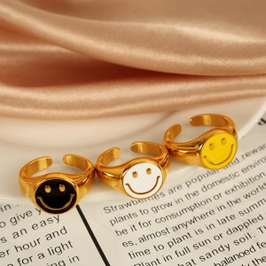 Three minimalist 18K gold-plated smiley face open rings in black, white, and yellow enamel