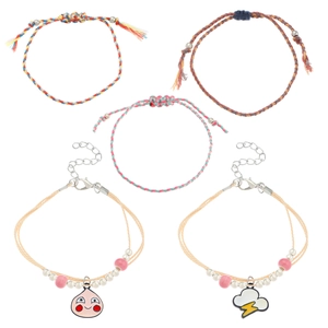 Detail of 5-piece bohemian woven friendship bracelets set with peach and cloud charms