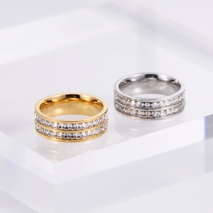 Detail of gold and silver double-row zircon rings with polished finish for couples