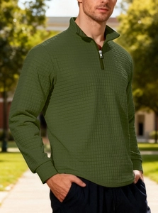 Detail of green men's half-zip sweatshirt with waffle texture fabric and high collar