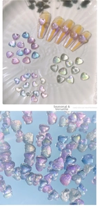 Macro detail of aurora heart nail gems with iridescent shimmer on decorative plate