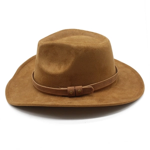 Detail of brown faux suede cowboy hat featuring leather band and vintage gold rivets