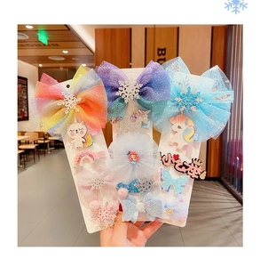 Close-up of Frozen-themed hair clips with rainbow bows, snowflakes, and mermaid motifs