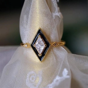 Detailed close-up of a vintage gold geometric ring featuring a clear rhomboid zircon inlay