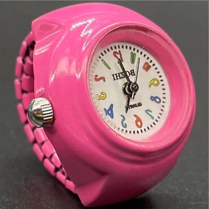 Close-up of pink quartz ring watch featuring a white dial with colorful numerals