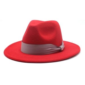 Detailed view of red wool fedora hat with silver ribbon and rhinestone buckle decoration