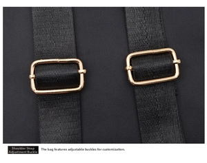 Detail of adjustable nylon shoulder straps with premium gold metal buckles on a black backpack