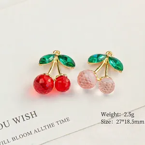Pastel cherry resin pendants in red and pink with emerald leaf accents and gold frame