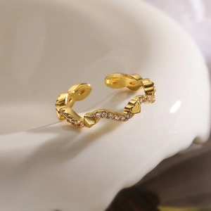 Minimalist 18K gold plated copper open ring with heart-shaped zircon on white ceramic