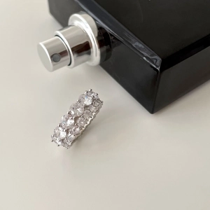 Macro detail of silver S925 ring featuring multiple rows of sparkling zircon stones