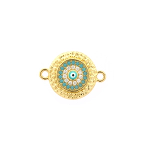 Macro shot of gold-plated evil eye pendant connector with turquoise and zircon stones