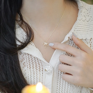 Elegant gold S925 sterling silver necklace featuring a double-layered bow pendant with zircons