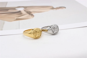 Detailed relief of cupid angels on vintage gold and silver titanium steel rings