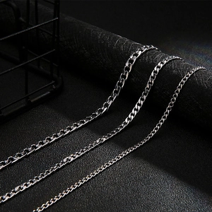Flat Cuban link necklace in silver stainless steel on a textured black background