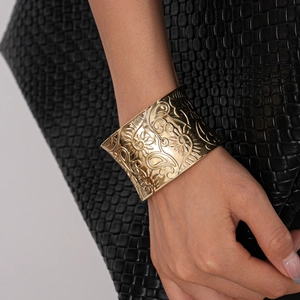 Golden wide open cuff bracelet with embossed bohemian floral and paisley patterns