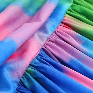 Macro shot of colorful tie-dye fabric with ruffle details and fine horizontal texture