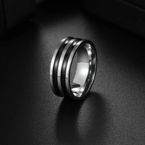 Detail of three-layer striped titanium steel ring with silver and black textured finish