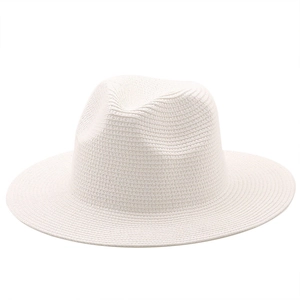 Detail of white woven straw fedora featuring a classic center-indented crown and wide brim