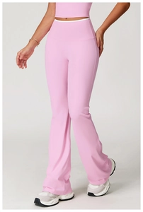 Detailed view of pink high-waist flared yoga pants with contrasting white waist piping