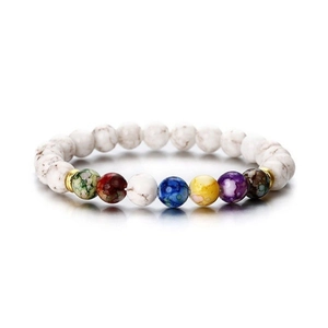 Close-up of 8mm white marble beads and seven chakra stones on an elastic bracelet