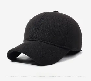 Close-up of a black winter baseball cap featuring a silver shield logo and fine fabric texture