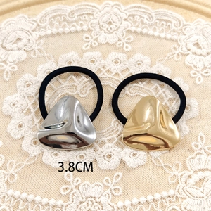 Close-up of gold and silver triangle alloy charms on black elastic hair ties, 3.8CM wide