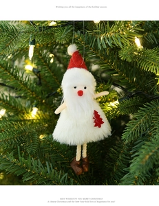 Close-up of plush Santa Claus ornament with a red hat hanging on a festive Christmas tree