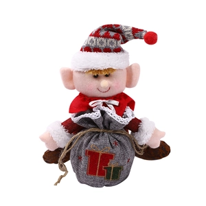 Cute Nordic Christmas elf plush toy holding a gift bag on a clean white background