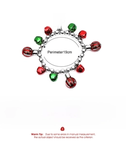 Detail of Christmas bell bracelet with red and green charms on silver bead chain