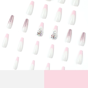 Pink and white coffin press-on nails with French tips, pink glitter, and rhinestone accents