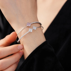 Detail of silver double-layer bangle with pink and white clover-shaped zircon stones