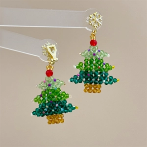 Detailed view of beaded Christmas tree earrings with crystal beads and snowflake stud