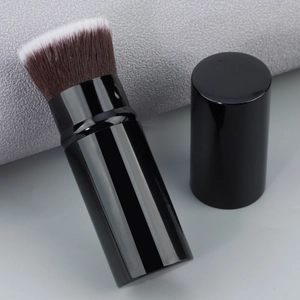 Macro shot of portable flat-top foundation brush with synthetic bristles and black cap