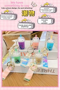 Detailed view of cat milk tea keychains with laser straps and golden metal clips