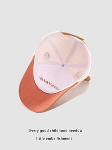 Detail view of cotton kids baseball cap showing inner happy kids embroidery and adjustable strap