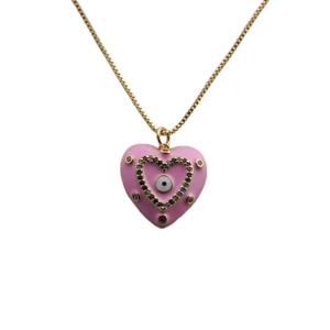 Detailed close-up of a pink heart pendant with evil eye motif and colorful gems on gold chain