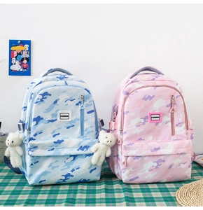 Blue and pink camouflage school backpacks with cute plush bear charms on side pockets