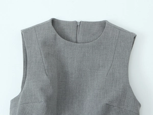 Detail of dark grey satin dress featuring a round neckline and hidden back zipper