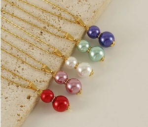 Detail view of 18k gold plated necklaces with pearl gourds in five assorted colors