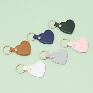 Minimalist heart-shaped leather keychains in six colors with golden metallic rings