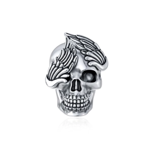 Detailed close-up of a silver skull bead with wing design and polished metal finish