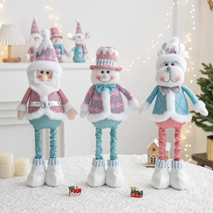 Detailed view of pink and blue plush Santa, Snowman, and Reindeer dolls on a table
