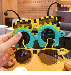 Detailed view of fun kids animal sunglasses including bee dinosaur and giraffe designs