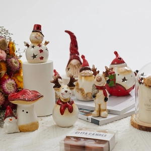 Vintage ceramic Christmas figurines including Santa, reindeer, and gnome with warm candles