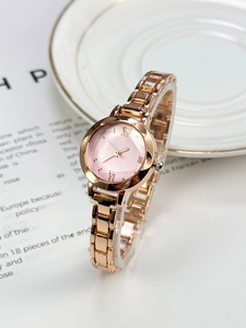 Close-up of elegant women quartz watch with pink dial and golden chain strap